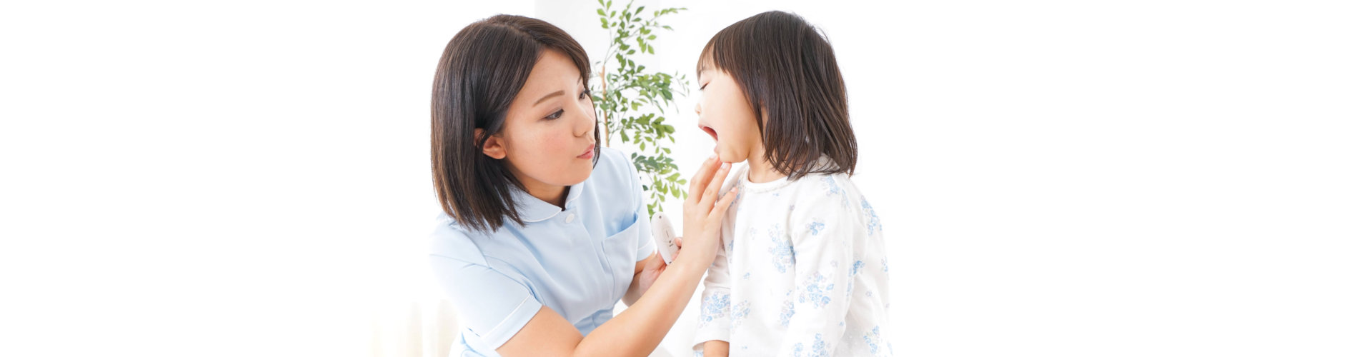 dentist checking little girls teeth